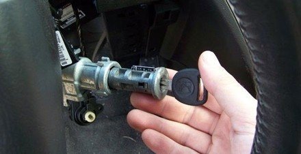Car ignition lock cylinder being removed for repair