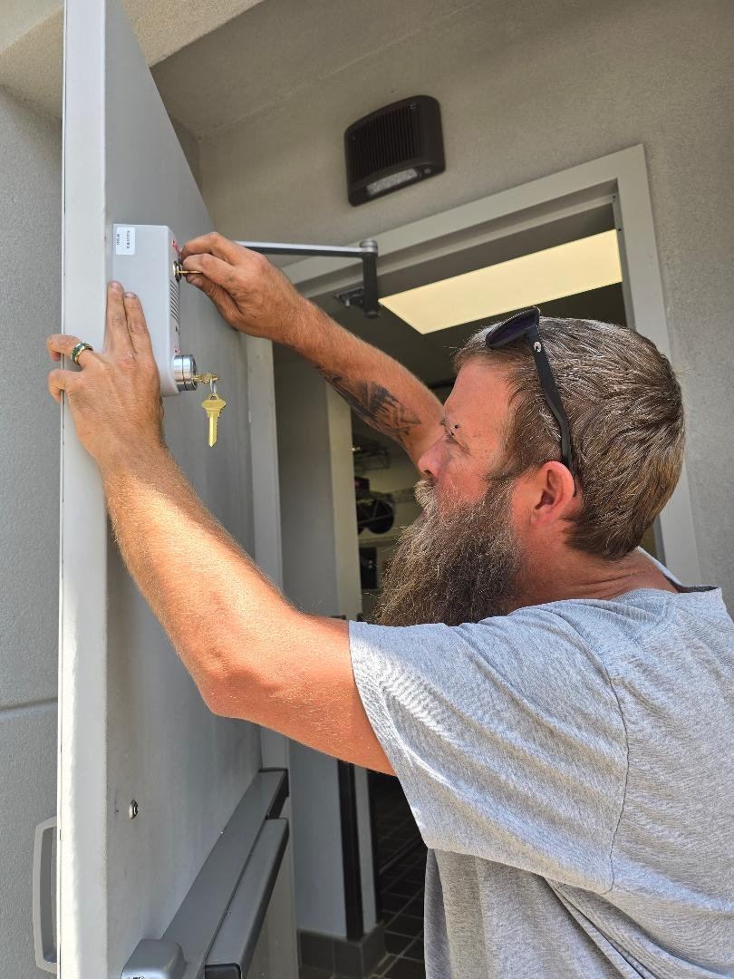 Adjusting a commercial door closer on a Hayman’s Locksmithing service call