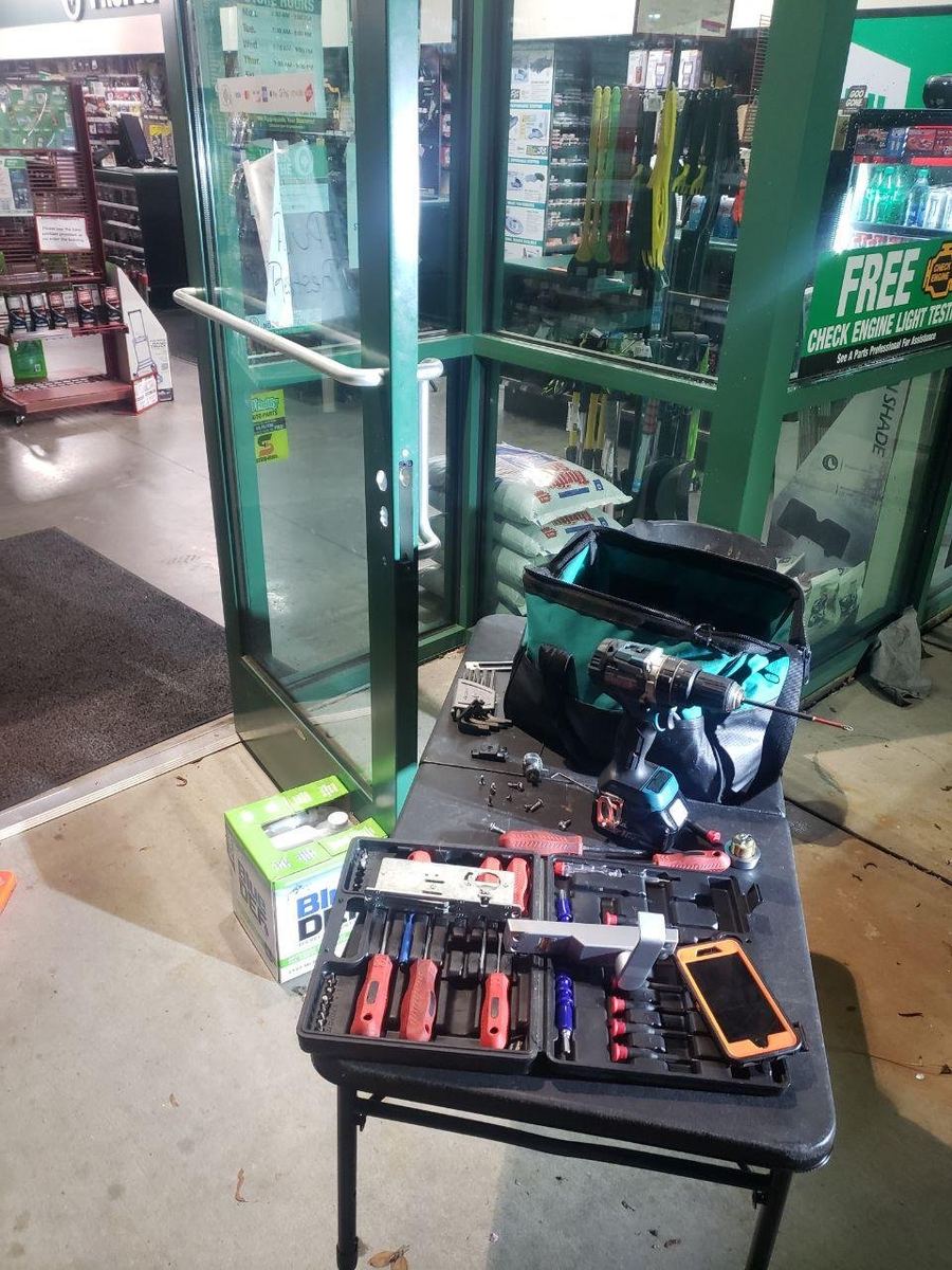 Locksmith tools set up at a storefront entrance