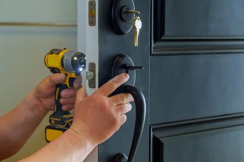Locksmith installing a new deadbolt on a front door